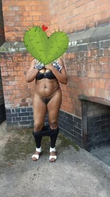 Black Derby wife posing outdoors.