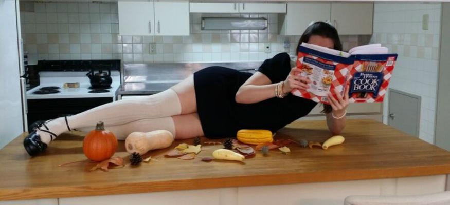 Petite woman in white kneesocks cavorts in the kitchen