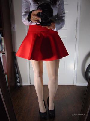 Miss Lauren in a red skirt showing her feet in white stockings