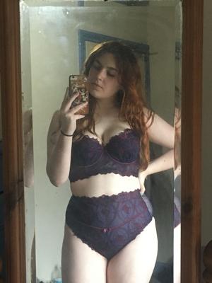 Curvy redhead taking selfies