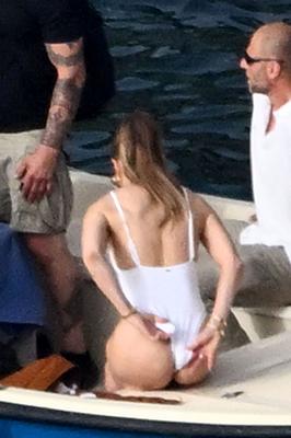 Jennifer Lopez   white swimsuit on boat in Italy   GRAINY