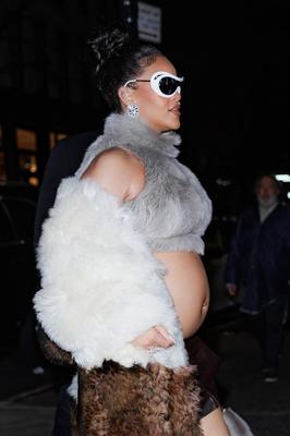 Rihanna - Shows off her bump in a fur coat 